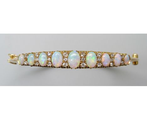 A 15ct gold opal and diamond bangle, 11.8g, central opal 0.7 x 0.5cm, 4.8 x 5.8 diameter