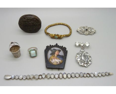 A white metal and moonstone bracelet (two stones missing) a silver and synthetic opal ring (lacking one stone), a white metal