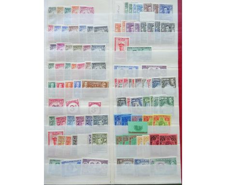 A vintage accumulation in over a dozen volumes, the core being five old-fashioned stockbooks of KGVI mint never hinged sets a