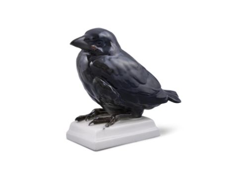 A SCHWAZBURGER WERK PORCELAIN MODEL OF A BLACK BIRD on a shaped square base. 18cm high
