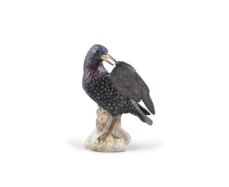 A 19TH CENTURY MEISSEN PAINTED PORCELAIN MODEL OF A STARLING one wing raised standing on tree stump, with blue crossed swords