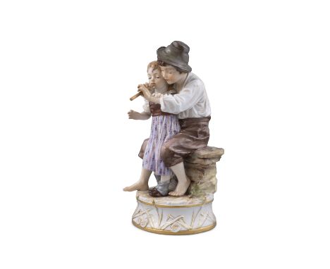 A 19TH CENTURY MEISSEN PAINTED PORCELAIN GROUP OF A SEATED YOUNG BOY, TEACHING A GIRL TO PLAY THE LUTE,on a circular base, in