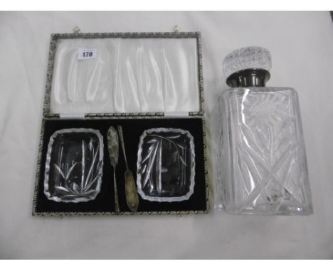 A CUT CRYSTAL DECANTER WITH HM SILVER COLLAR  PLUS A PAIR OF BOXED CUT CRYSTAL BUTTER DISHES WITH SILVER BUTTER KNIVES