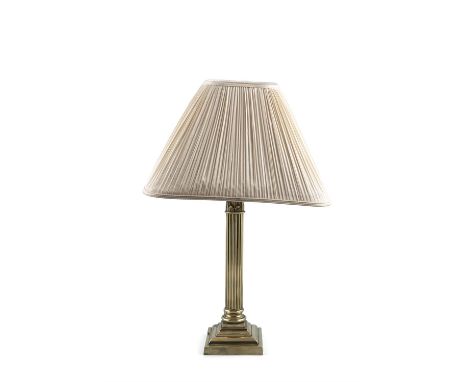 A GILT BRASS TABLE LAMP, with fluted Corinthian column raised on stepped platform base, with cream shade 