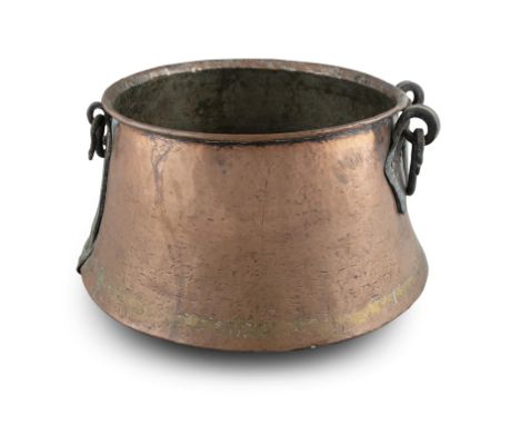A NORTH AFRICAN COPPER BASIN WITH IRON HANDLES, 20th Century. 41cm wide