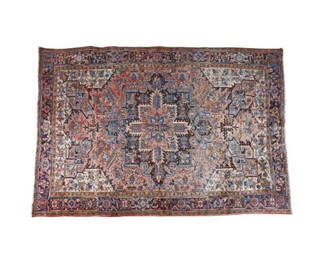 A PERSIAN HERIZ WOOL CARPET, mid-20th century, of rectangular shape, centred with a large four point medallion and surrounded