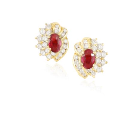A PAIR OF RUBY AND DIAMOND EARRINGS, each composed of a central oval-shaped ruby within a surround of brilliant-cut diamonds,
