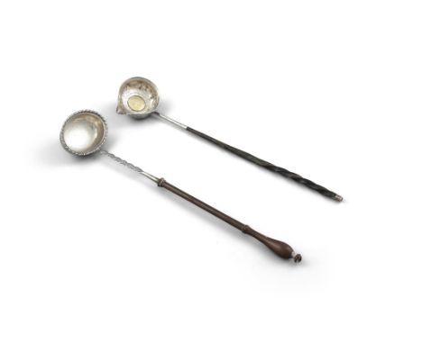 A WHITE METAL TODDY LADLE, with inset George II crown and applied turned ebonised handle; together with another white metal e