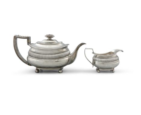A 19TH CENTURY SILVER TEAPOT AND CREAM JUG, hallmarks rubbed, the teacup of oblong form, with angular acanthus leaf wrapped h