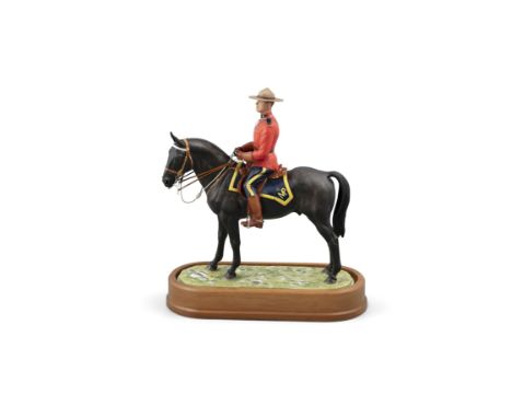 A ROYAL WORCESTER PORCELAIN MODEL OF A ROYAL CANADIAN MOUNTED POLICEMAN, modelled by Doris Lindner, model no.435/500, set int