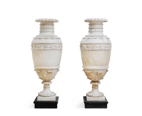 A PAIR OF CARVED ALABASTER URNS, 19TH CENTURY, IN THE NEOCLASSICAL STYLE, each of amphora shape, each with a central frieze d