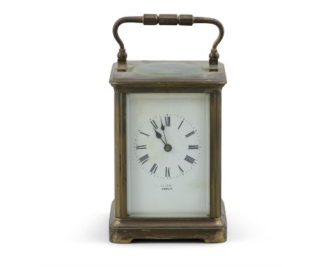 AN EDWARDIAN BRASS CASED CARRIAGE CLOCK, with striking movement, the white enamel dial inscribed indistinctly with the name o