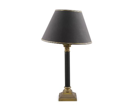 A GILT AND BLACK PAINTED TABLE LAMP, the fluted Corinthian column raised on stepped platform base with black shade, 48cm high