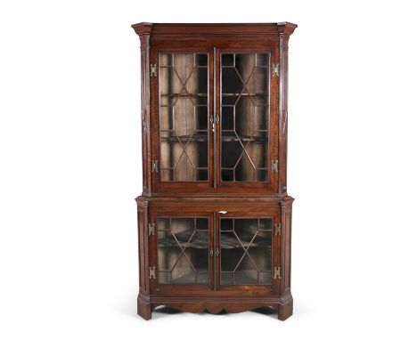 A GEORGIAN STYLE MAHOGANY CORNER CABINET, in two parts, with moulded cornice above twin astragal glazed panel doors on a conf