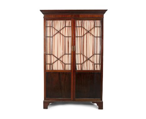 A GEORGE III MAHOGANY GENTLEMAN'S WARDROBE, with moulded dentil cornice and astragal glazed doors with pleated curtain backdr