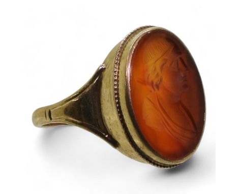 A CARNELIAN INTAGLIO RING carved with a gentleman, in a 9ct gold ring mount, finger size P1/2, weight 4gms Condition Report:A