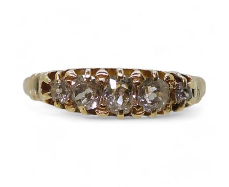 A FIVE STONE DIAMOND RING set with estimated approximately 0.55cts of old cut diamonds in a yellow metal setting, finger size