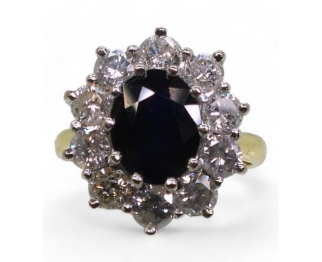 A SUBSTANTIAL CLUSTER RING, set with a 9.5mm x 7.5mm x 4.7mm oval cut sapphire, surrounded with estimated approx 1.50cts of b