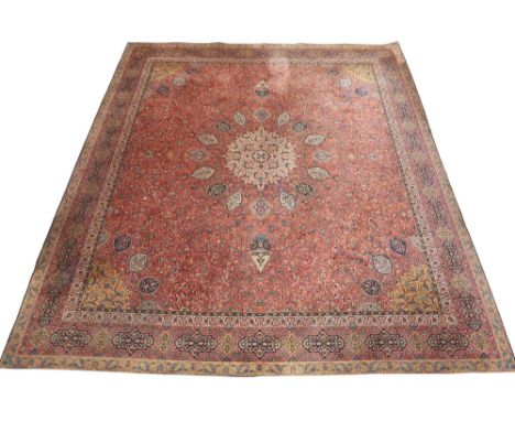 A LARGE TERRACOTTA GROUND TEMPLETON "ARRAN" PERSIAN STYLE CARPET  with cream sunburst central medallion on floral/foliate pat