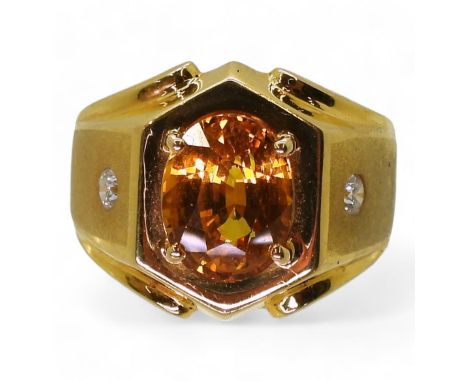 A STATEMENT DRESS RING set with a synthetic yellow sapphire and two diamonds, made in bright yellow metal finger size T, weig