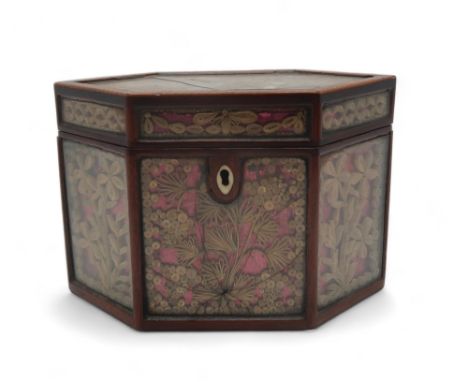 A GEORGE III QUILLWORK OR SCROLLED PAPER TEA CADDY of hexagonal form with chequer band strung lid, the metallic scrolled pape