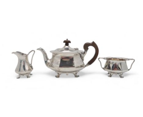 A MATCHED GEORGE V SCOTTISH THREE PIECE SILVER TEA SERVICE by James Weir, Glasgow 1918, the teapot 1921, of faceted form, wit