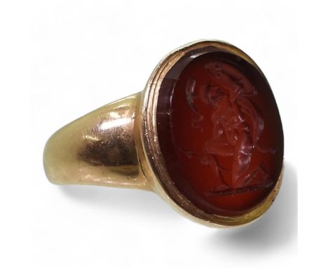 A GLADIATOR INTAGLIO RING the carved carnelian, is set in a yellow metal ring, the inner shank inscribed To John Buchanan, wi