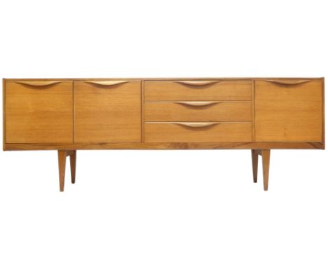 A MID 20TH CENTURY TEAK VICTOR WILKINS FOR G PLAN SIDEBOARD&nbsp; with three graduating drawers flanked by pair of cabinet do