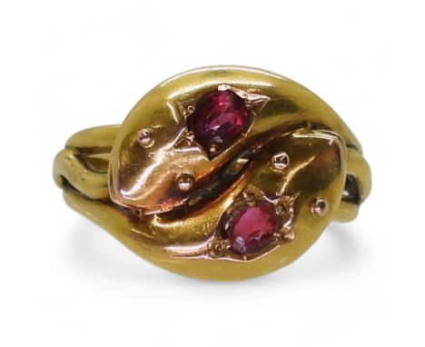 A SNAKE RING the double heads are set with a ruby and a red gem, Chester hallmarks for 1915, made by John Henry Wynn of Birmi