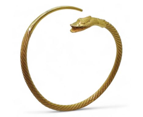 AN ARABIC GOLD SNAKE BANGLE the twisted wire body has a springy feel to it, with solid tail and head, stamped with Arabic gol