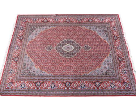 A RED GROUND TRADITIONAL BIJAR CARPET  with dark and light blue central medallion and matching spandrels on recurring pattern