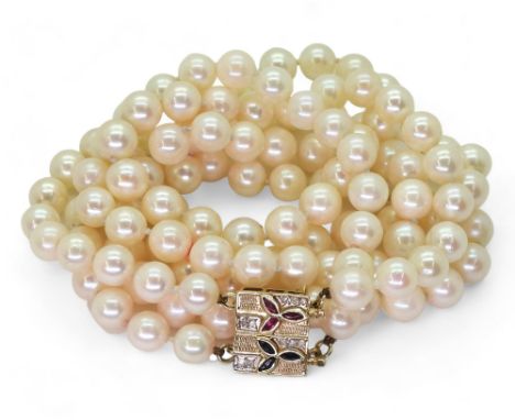 PEARLS WITH A METAMORPHIC CLASP the double string of pearls has a ruby sapphire and diamond 14k gold clasp, which can be used