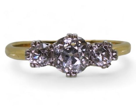 A THREE STONE DIAMOND RING with a pretty scroll design galleried 18ct mount, set with estimated approx 1.20ct in total. Finge