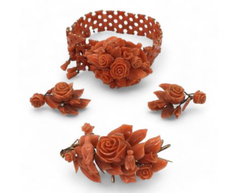 A SUITE OF CORAL JEWELS a bracelet, with carved flowers and leaves, yellow metal clasp, can be shortened or extended with the