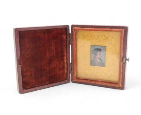 AN ENAMEL MINIATURE PORTRAIT OF A MAN possibly John Calvin, with gilt metal surround and housed within a velvet lined leather