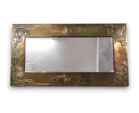 A SCOTTISH SCHOOL BRASS FRAMED MIRROR with central repousse decoration of a ship, with celtic knotwork to each corner, 66cm x