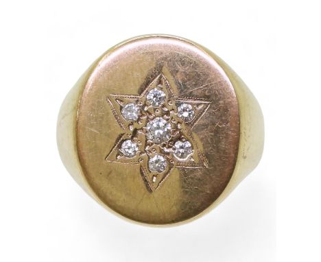 A SUBSTANTIAL GENTS SIGNET RING engraved with a star and set with brilliant cut diamonds, with an estimated combined total of