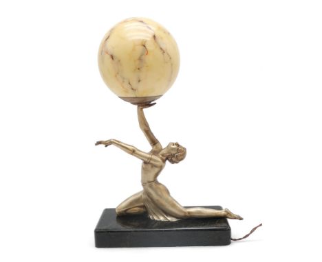 AN ART DECO GILDED METAL LADY LAMP modelled kneeling with arms outstretched, balancing a mottled glass globe shade, the whole