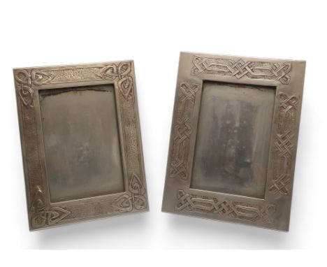 A GLASGOW SCHOOL WHITE METAL FRAME decorated in relief with Celtic knotwork panels, 28.5cm x 21.5cm together with another fra