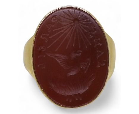 A CARNELIAN INTAGLIO RING carved with a Phoenix rising from the flames with the motto Sans Pareil - without Equal. In a 9ct g