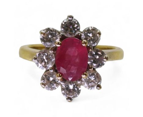AN 18CT GOLD RUBY &amp; DIAMOND RING set with an 7.9mm x 5.9mm x 2.9mm, oval cut ruby, surrounded with estimated approx 1.40c