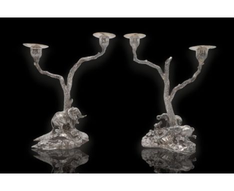 PATRICK MAVROS; a pair of silver twin-light candelabra, Zimbabwe 1996 / 98, cast with bull elephants, the other with females 