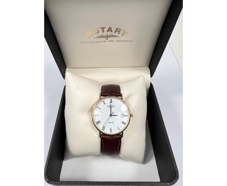 A 9ct gold backed gents Elite Rotary wristwatch with white dial Roman numerals, date aperture on brown leather strap in box 