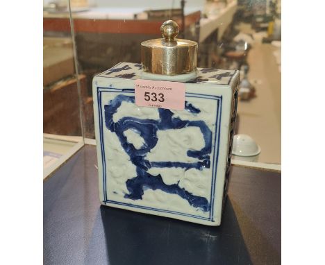 An 18th century Chinese blue an white square tea caddy with relief decoration, later hallmarked silver lid and collar, height