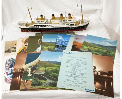 A wooden model of the Titanic and a selection of Cunard cruise menus RMS Queen Elizabeth , Queen Mary from the 50's and 60's 