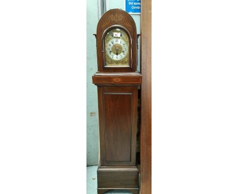 An Edwardian arch top clock in inlaid mahogany case with chiming movement 