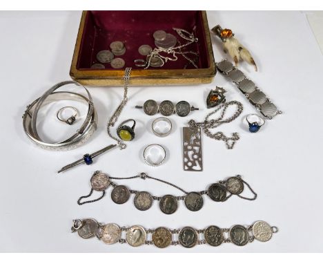 A hallmarked silver bangle; an engine turned bracelet; a Scottish white metal paw brooch set blue stone; a white metal dress 