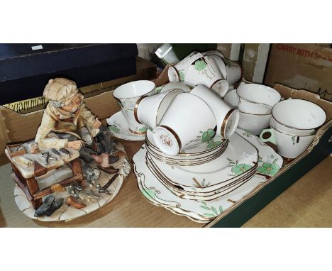 An Art Deco Wellington part tea service, 40 pieces approx. + A Capodimonte group: Shoemaker 