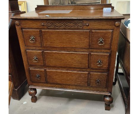 An oak 1930's chest of three drawers with bulbous legs and panel fronted decoration, height 100cm, width 90cm 