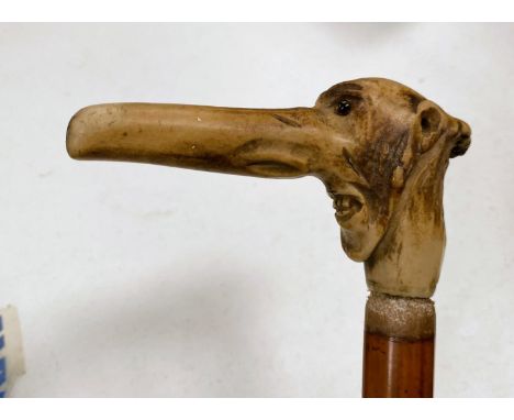 A 19th century novelty walking stick, the horn handle carved in the form of a grotesque face; a mantle clock and barometer&nb